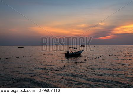 A Speed Boat Moored At Melina Beach, Tiomen Island, At Sunset, Malaysia