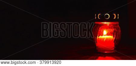All Saints Day Candle. Red Votive Candle On Dark Background