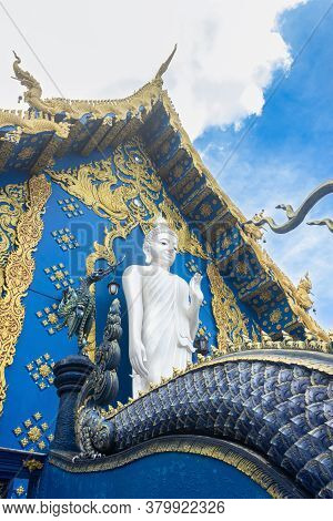 Chiangrai, Thailand - June 7, 2020: Standing White Buddha On Yellow Blue Wat Rong Suea Ten Church Ba