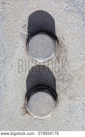 Large Head Bolts On Metal Construction As Background - Engineering Concept. Metal Heads Of Two Bolts