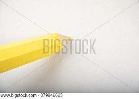 Yellow Pencil Stands On A White Background.