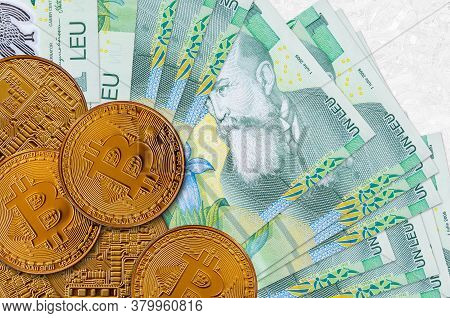 1 Romanian Leu Bills And Golden Bitcoins. Cryptocurrency Investment Concept. Crypto Mining Or Tradin