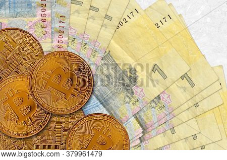 1 Ukrainian Hryvnia Bills And Golden Bitcoins. Cryptocurrency Investment Concept. Crypto Mining Or T