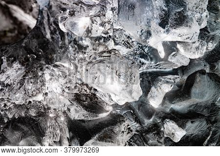 Big Piece Of Ice With Abstract Cracks Inside. Icicle Block Indetail With Frozen Bubbles.