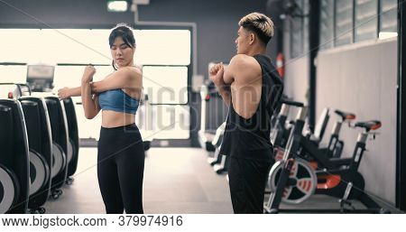 Healthy Two People Young Asian Doing Stretching Leg After Workout At Fitness Gym, Cooldown Muscle He