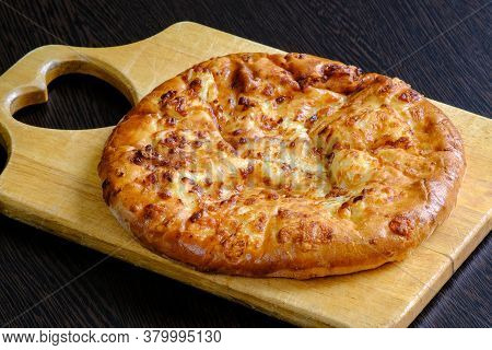 Georgian Cuisine Is National Cheese Cake Hachapuri Mergoli On A Cutting Board. The Concept Of Health