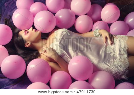 Sleeping Woman Lying On Floor Among Balloons