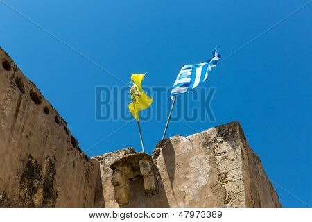 National Flag On The Roof Of Monastery (friary) In Messara Valley At Crete Island In Greece.
