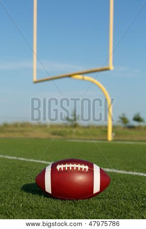 American Football auf dem Feld und Torpfosten jenseits