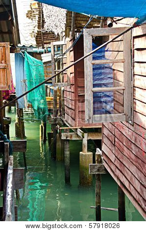 Between houses on stilts