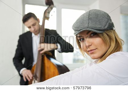 Woman Face And Contrabas Player On Backbround