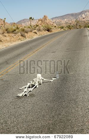 A lost hiker dies of thirst on a deserted desert road inches away from a bottle of water.  Dark Humor Series. 