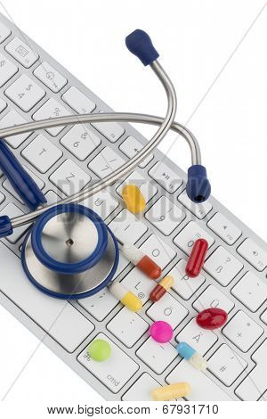 tablets on keyboard symbol photo for online pharmacies and drug costs