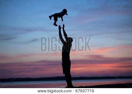 Young dad playing with his son