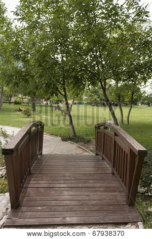 Wooden Bridge Near The Lake In The Park