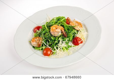 Salad from eruca and shrimps a white background