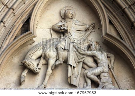 PARIS, FRANCE - NOV 11, 2012: Saint Martin of Tours, tympanum of St Severin Church. It is one of the oldest churches on the Left Bank situated in the Latin Quarter.