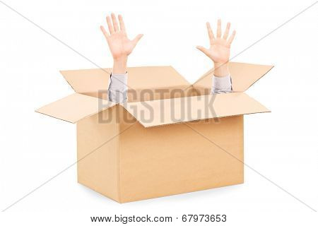 Hands arising from a carton box symbolizing surrender isolated on white background