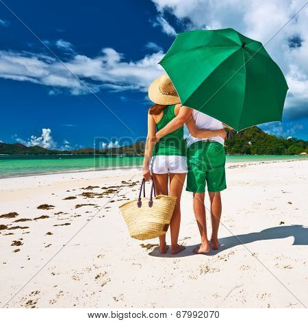 Couple in green on a tropical beach at Seychelles