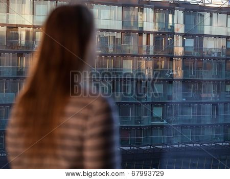 Woman looking at an apartment block