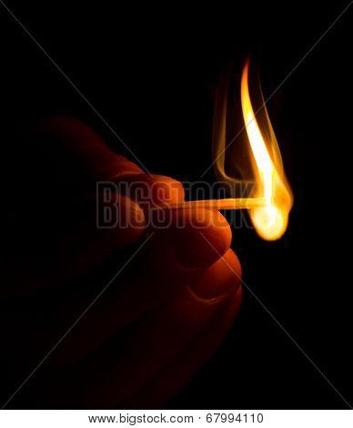 Hand with burning match