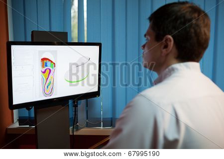 Orthopaedist at work with digital footstep model