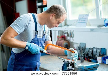 young worker on work bench in the factory
