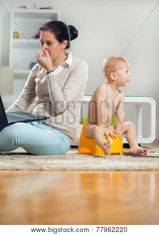 Working mother working at home and not watching his child to the potty