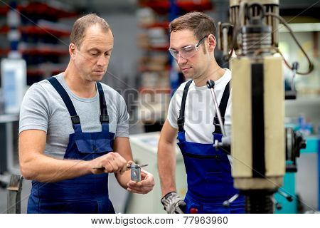 worker in factory on the machine