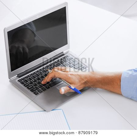 business, office, school and education concept - smiling businessman working in office