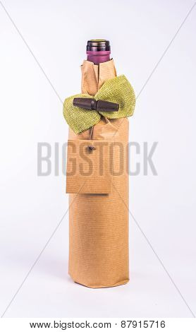 one bottle wrapped in paper decorative bow and blank card