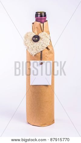 one bottle wrapped in paper with decorative heart and blank card