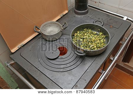 Pan With Zucchini Baked In Cast Iron Stove With Fire Lit