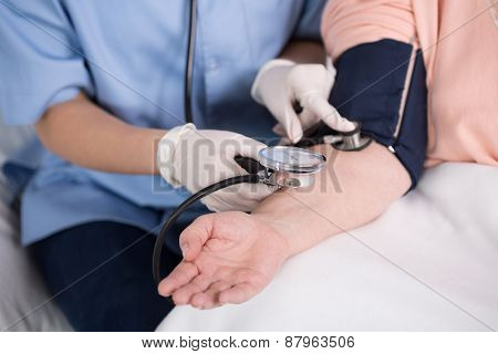 Nurse Using Blood Pressure Meter