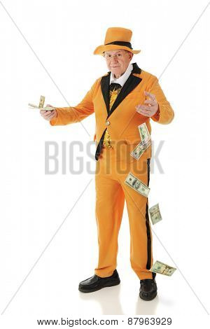 A flamboyant senior adult in a bright orange tuxedo and hat, carelessly offering money and dropping big bills.  On a white background.