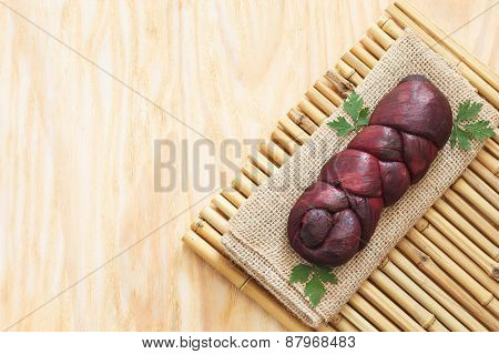 Treccia Braided Mozzarella Marinated In Red Wine On Sackcloth, Bamboo Board