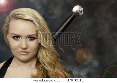 Attractive blonde woman with a sword