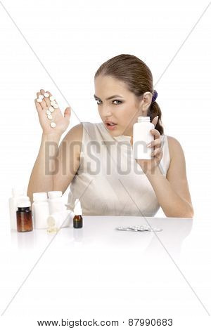 Young Woman Showing Question Mark Made From Pills On Palm