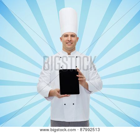 cooking, profession and people concept - happy male chef cook showing tablet pc computer black blank screen over blue burst rays background