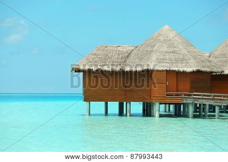 Water villas over blue ocean in Baros Maldives
