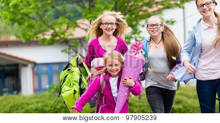 Group of students going back to school running on the schoolyard