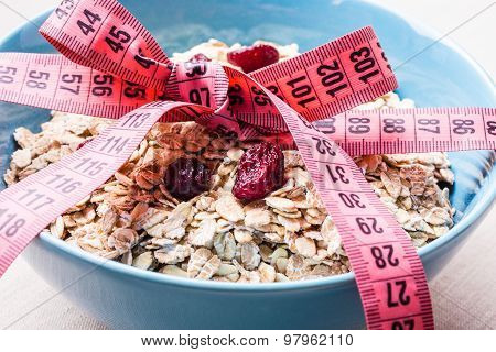 Oatmeal In Blue Bowl With Measuring Tape Around