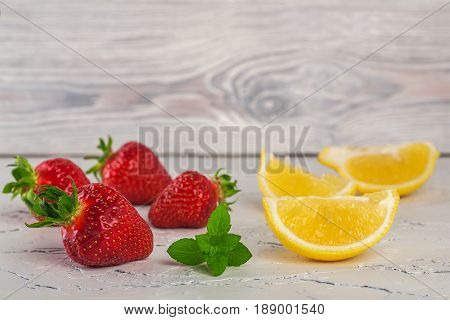 Strawberry With Lemony Mint On White Stone