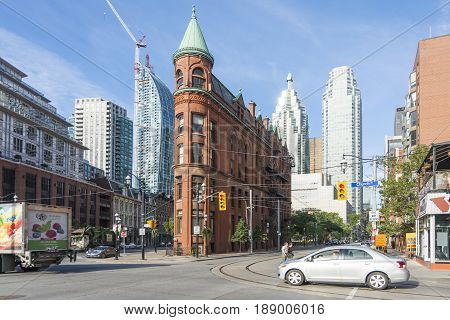 TORONTO,CANADA-AUGUST 2,2015:view of the Gooderham Building (the Flatiron Building) in downtown Torontowith some modern buildings and skyscrapers in the background during a sunny day.