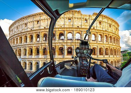 Helicopter cockpit with pilot arm and control console inside the cabin on Colosseum of Italy. Symbol of Rome, located in historical center, Unesco Heritage Site.