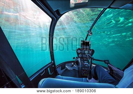 Underwater submarine ship cockpit in the blue ocean with sunbeams and copy space. Undersea background. Travel concept.