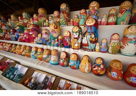 MOSCOW, MAY 26, 2017: Different colors Russian dolls matreshka at souvenir market shop. Traditional classic Russian handicraft art background. Famous classical and modern russian dolls matreshka toys