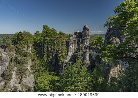 Big rocks near Bastei bridge in valley of river Elbe or Labe in spring sunny day