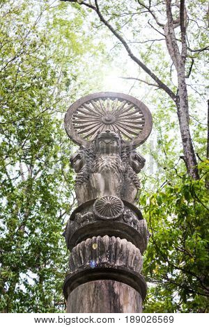 Asoka concrete pillar under tree shade Budhism symbolic and believe