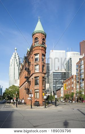 TORONTO,CANADA-AUGUST 2,2015:view of the Gooderham Building (the Flatiron Building) in downtown Torontowith some modern buildings and skyscrapers in the background during a sunny day.